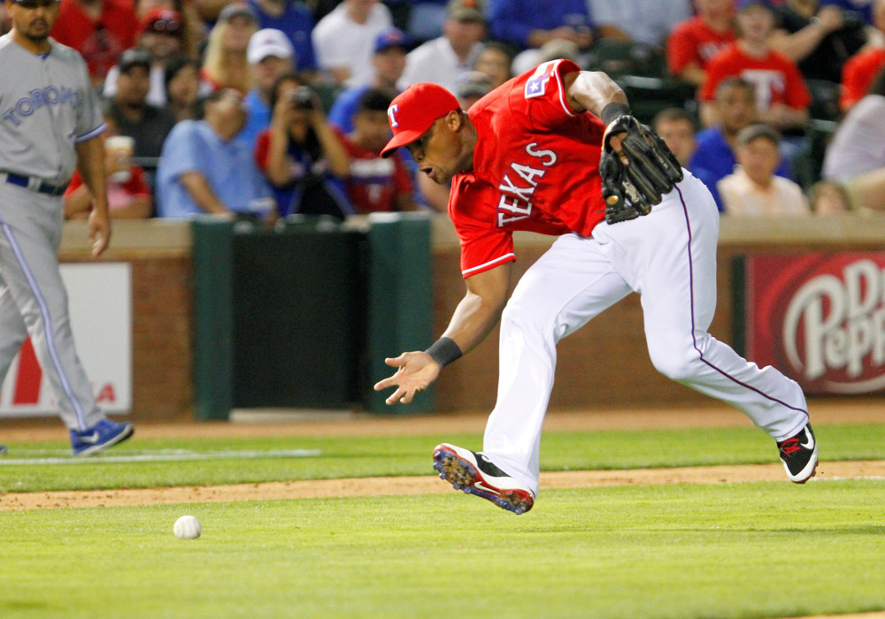 Adrian Beltre barehands a ground ball.