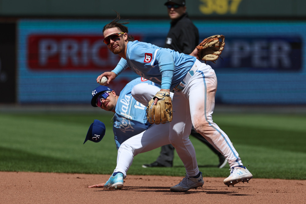 Bobby Witt Jr. prepares to make a throw after avoiding a collision with one of his teammates.