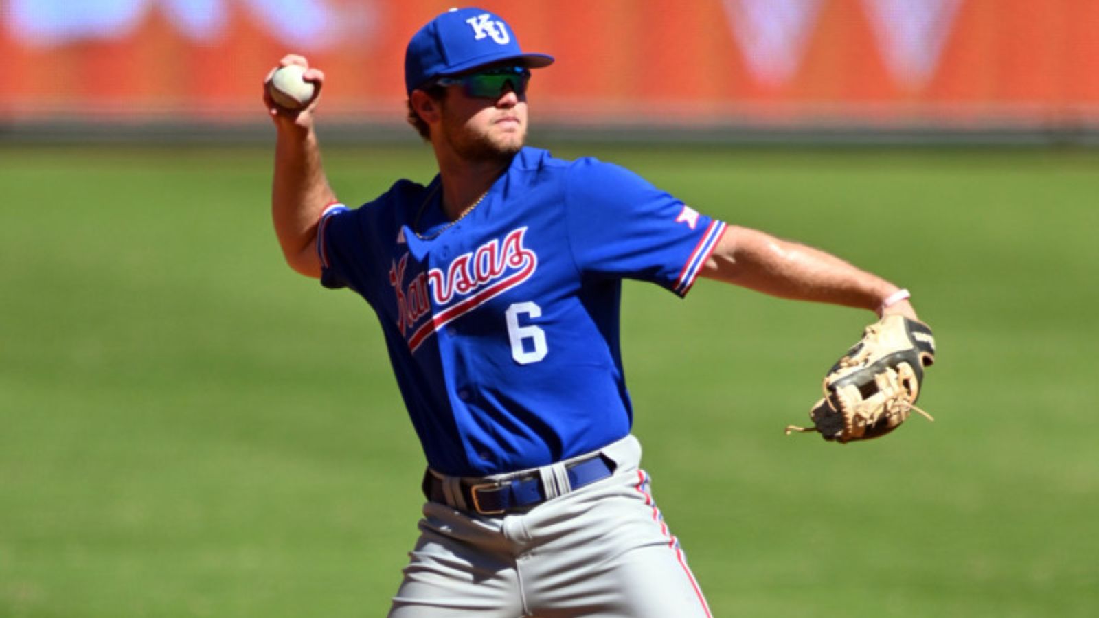 Kansas' versatile infielder Michael Brooks throws the ball to first base.