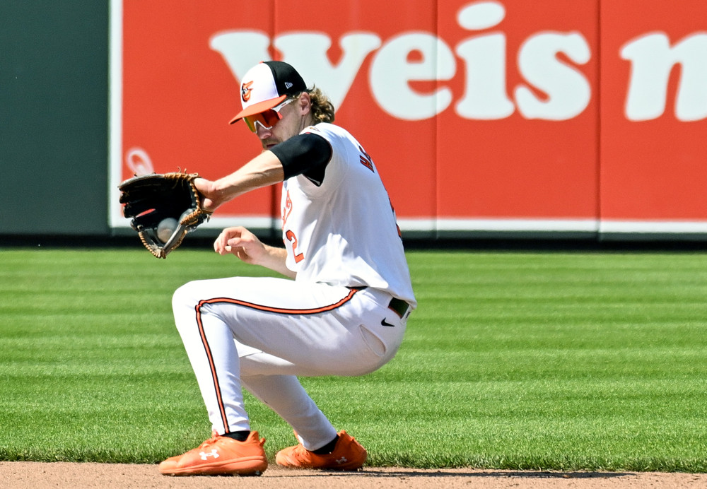 Gunnar Henderson backhands a ball at shortstop.