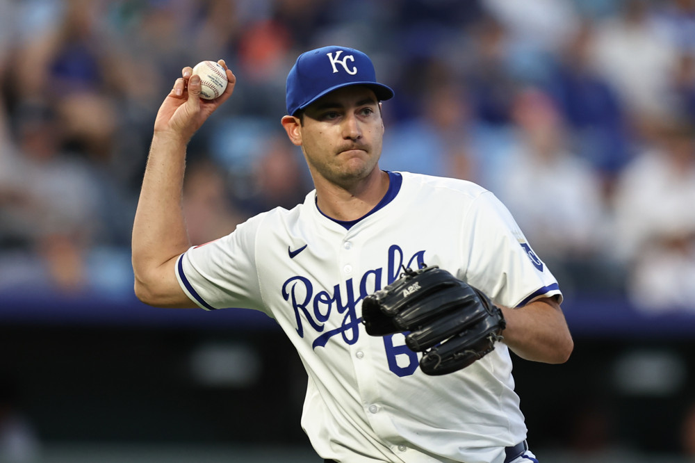 Seth Lugo prepares to throw the ball to first base.