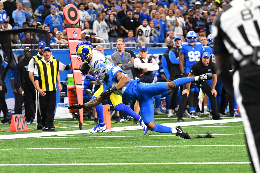 Cooper Kupp gets tackled along the sideline by a Detroit Lions player