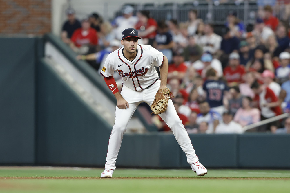 Matt Olson leans overs slightly and waits for a pitch to be thrown from his position at first base.