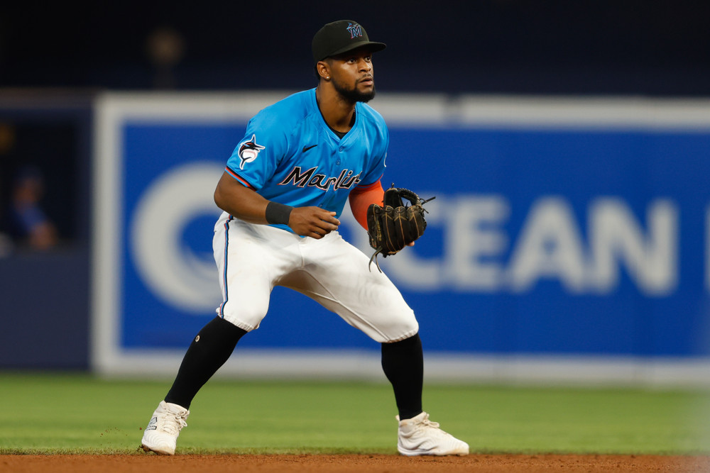 Otto Lopez, stands with his knees bent slightly, ready to field a ball at shortstop.